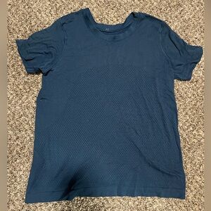 Used Lululemon short-sleeved shirt with stretched collar. Unsure of exact size.